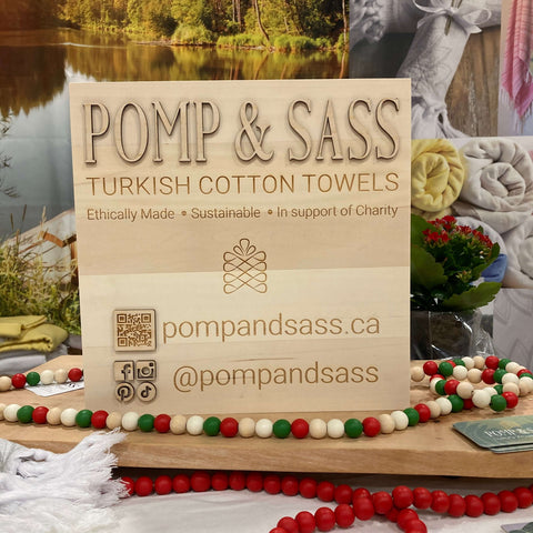 Pomp & Sass Turkish Cotton Towel Sign in wood at the Seasons Christmas Show booth