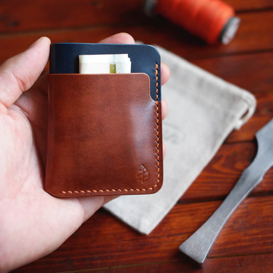The Vertical Card Holder in Italico Radica and Blue Gaucho Oil full grain vegetable tanned leather held in hand