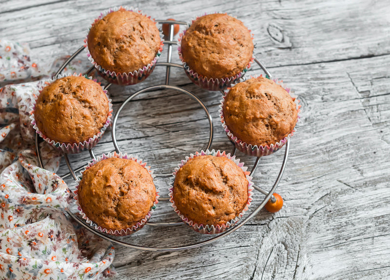 Batch of banana muffins on a metal cooling rack