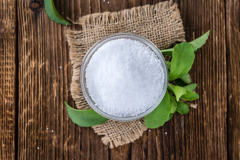 Stevia in a bowl on a wooden table