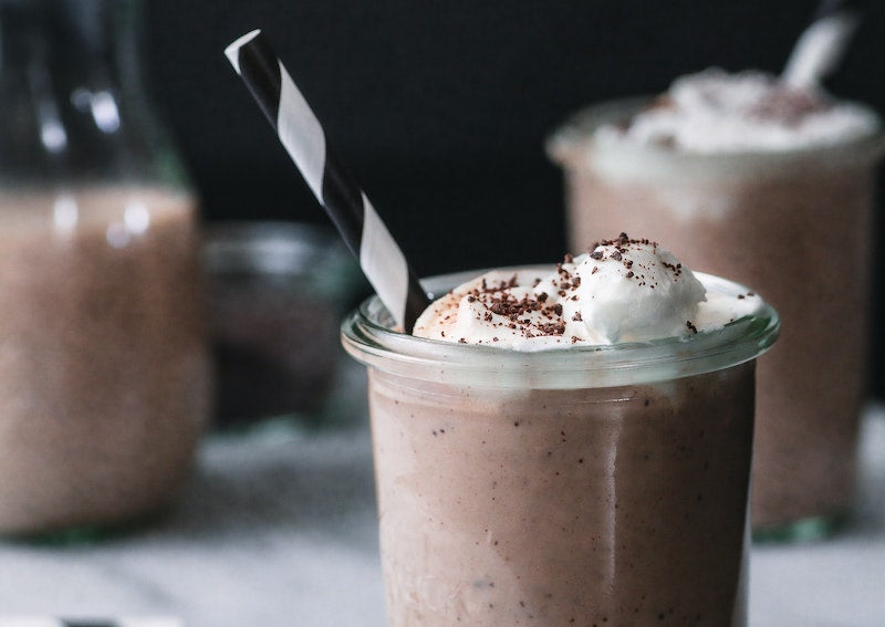 Glass of chocolate milk topped with whipped cream