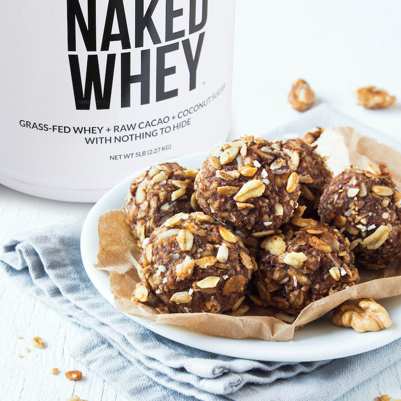 Tub of Naked Whey next to a plate of homemade protein bites