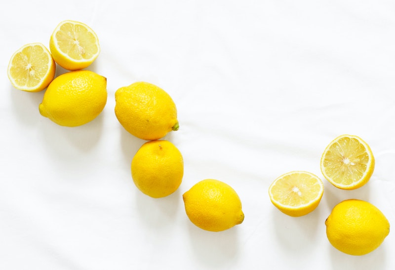 Aerial view of various cut up and whole lemons on a countertop