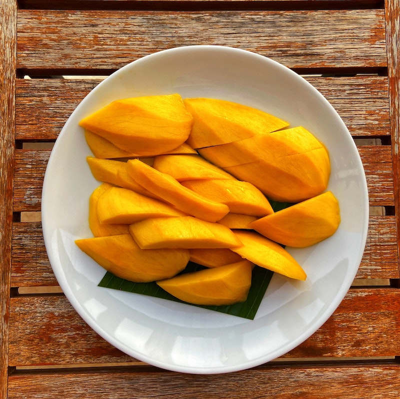 Aerial view of mango slices on a plate