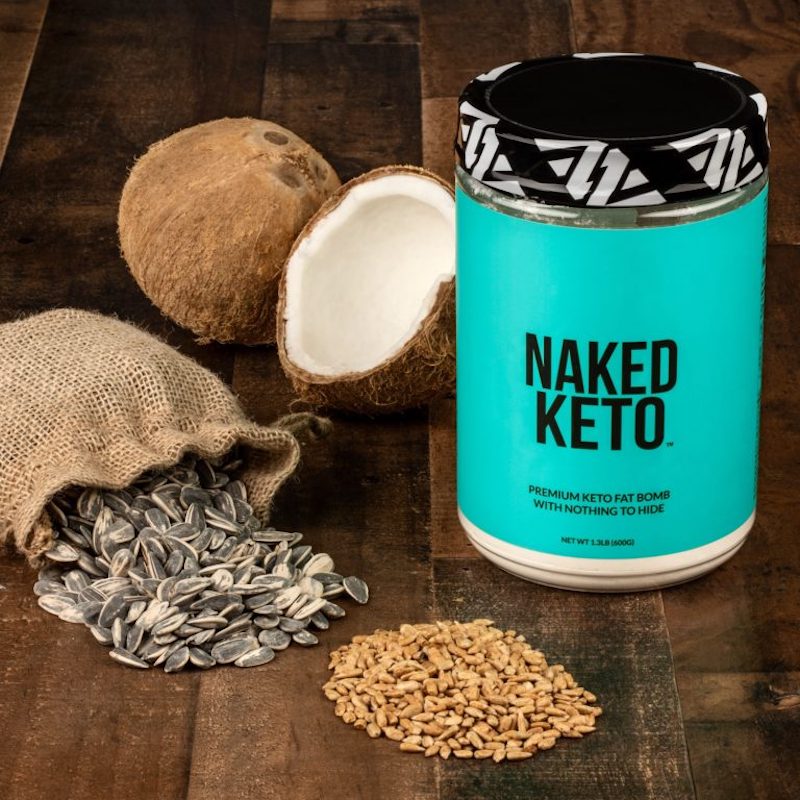 Naked Keto product image with some of the product's ingredients on the table surrounding it