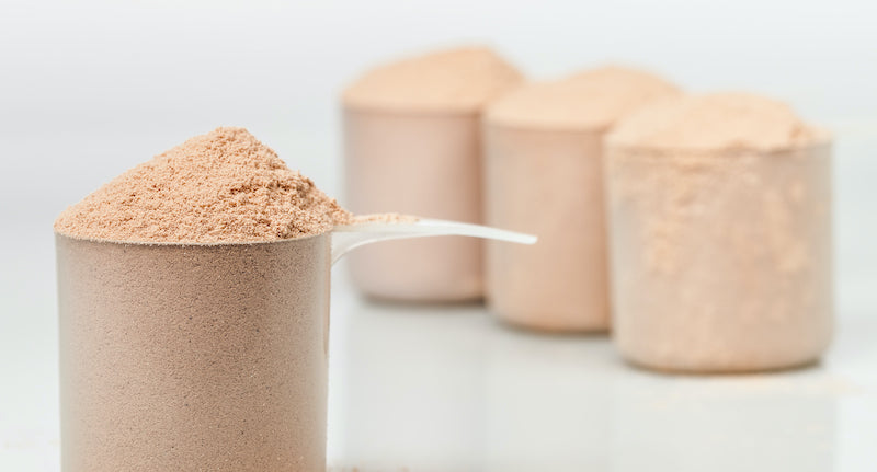 Four scoops of chocolate whey protein powder 
