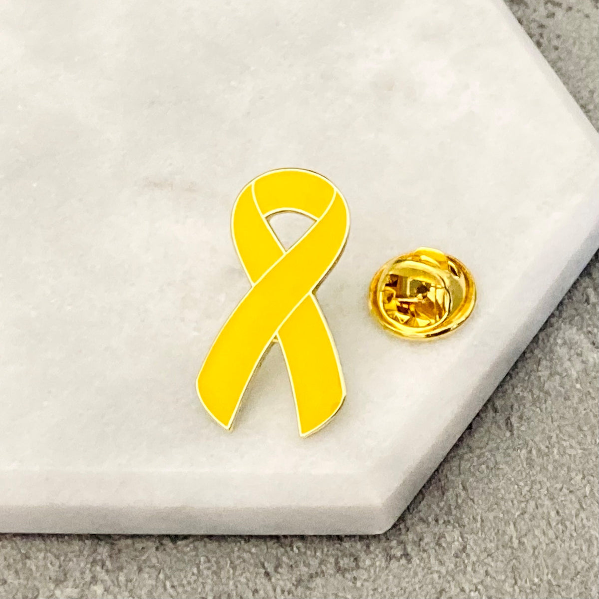yellow awareness ribbon pin cancer