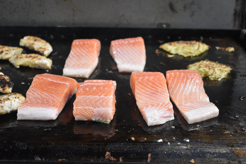 salmon cooking on mild steel plates