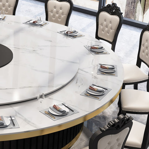 white chairs around white round table with silver tableware