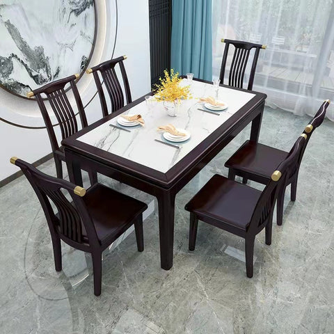 A sophisticated dining table with a marble top and dark wooden chairs set against an artistic backdrop, perfect for a section on design and aesthetics in home furniture
