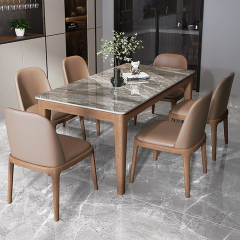 Modern dining room featuring a marble table with tan leather chairs, exemplifying sophisticated design and the importance of proper care for premium materials.