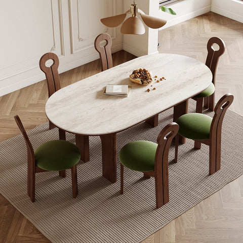 Elegant modern oval multifunction table with green upholstered chairs set in a bright room, illustrating versatility in furniture design
