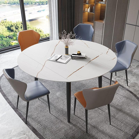 round extended dining table with four chairs