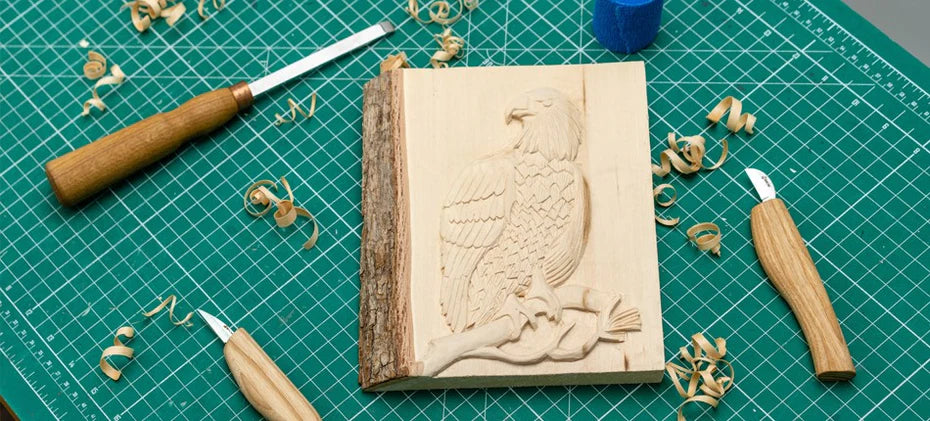 carved wooden eagle with tools