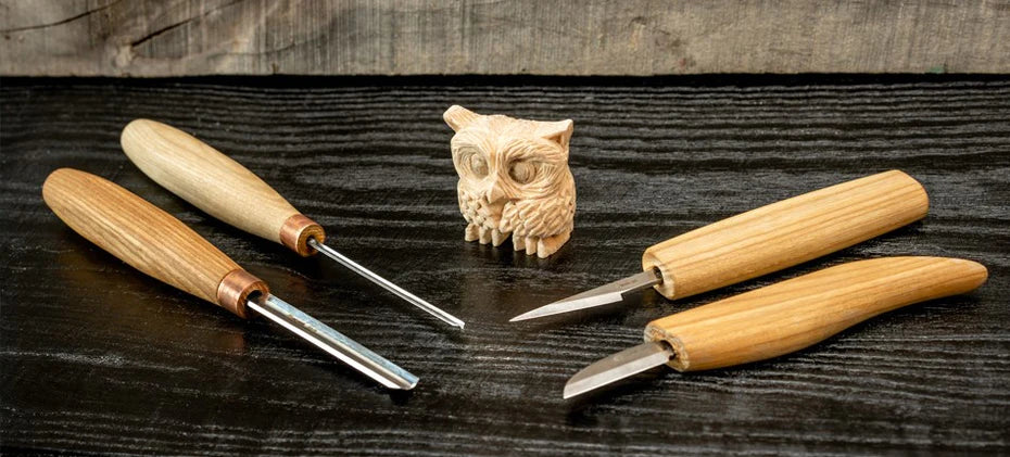 wooden owl with carving tools