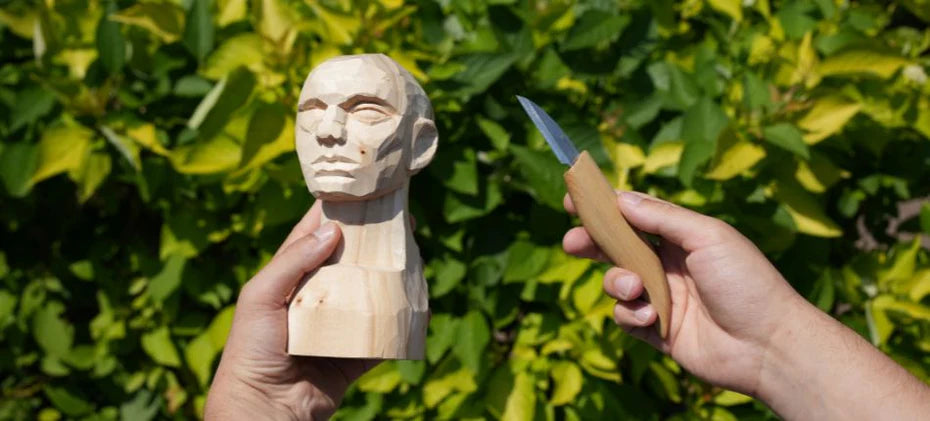 wooden statue with carving knife