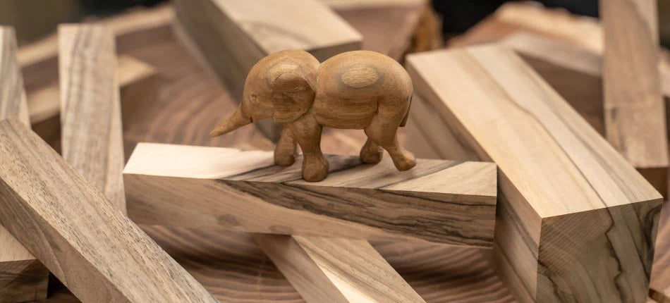 carved elephant on walnut wooden blocks