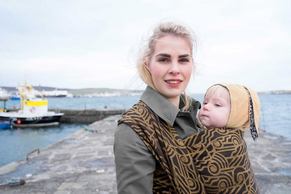 using a hat with ties to keep warm when babywearing