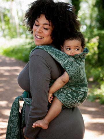 Mum back carrying in a baby carrier