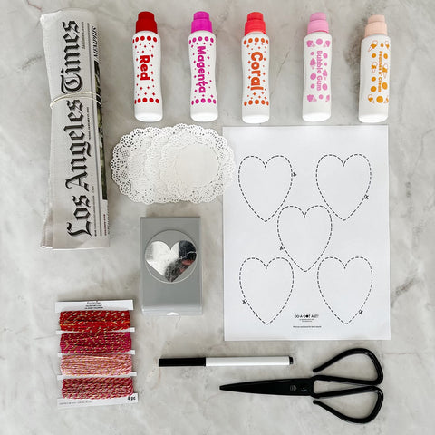 All supplies needed to make Valentine's Newspaper Garland with Do A Dot Art!