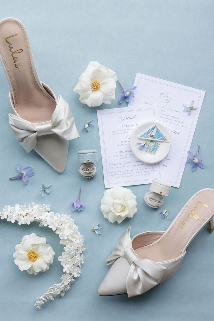 wedding day flat lay with french blue and traverse bay blue details with a suede rollable styling mat