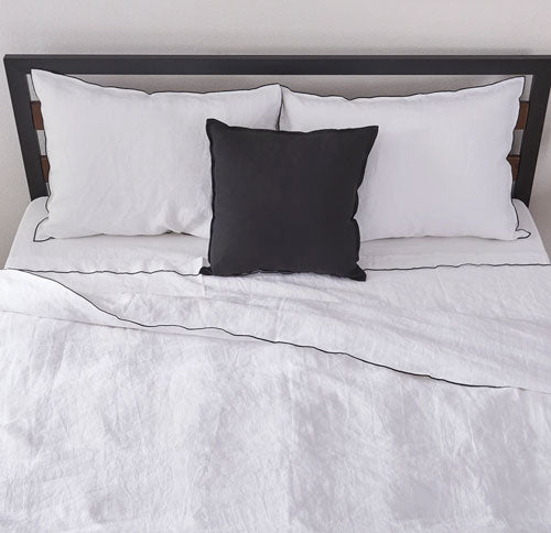 Black Edge Embroidered Linen Duvet Cover and Pillowcases on Bed
