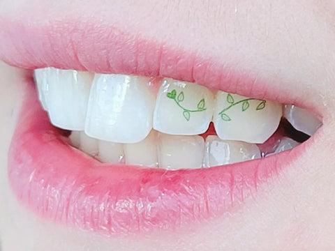 A tattoo on a tooth using multiple teeth of a green vine.  Also known as a temporary tattooth