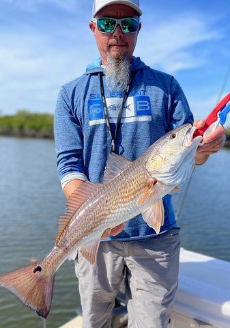 Captain Ken Craig holding a fresh catch