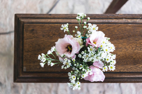 pink and white flowers on a casket