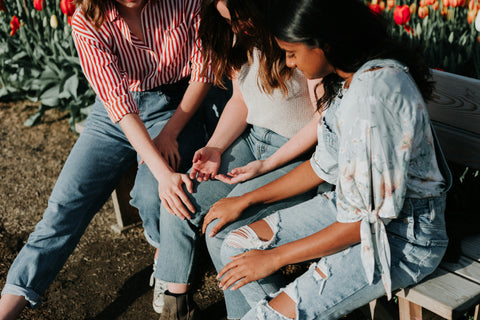 Friend group consoling another friend