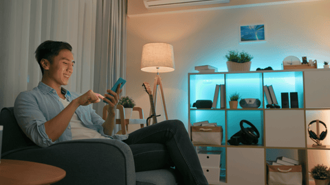 Sitting Man Using Smart Home Lighting