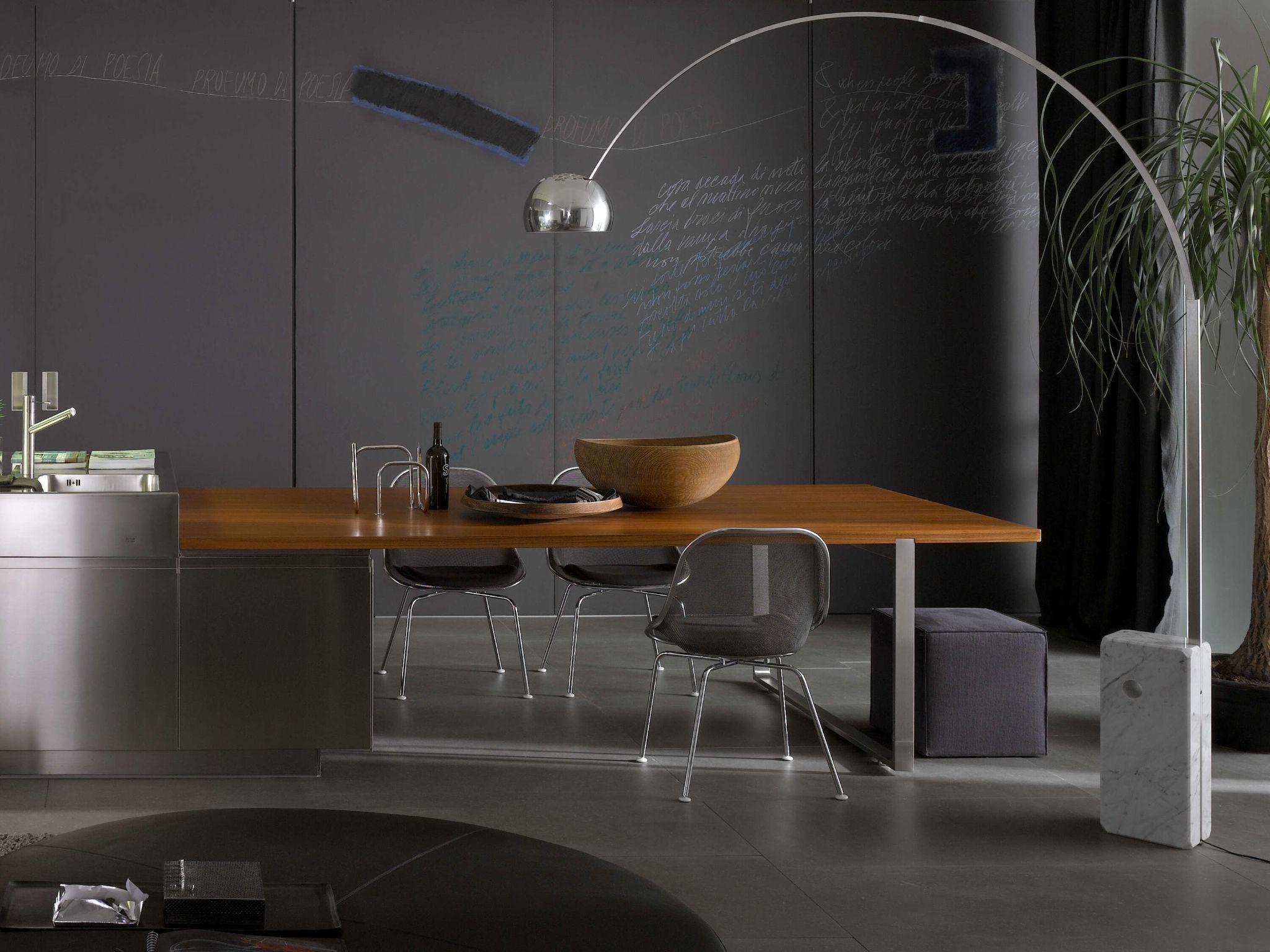 Black interior walls with modern dining table and telescopic designer floor lamp Singapore - ‘Arco Floor Lamp’ by Flos