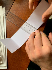 hands folding cardstock with score line