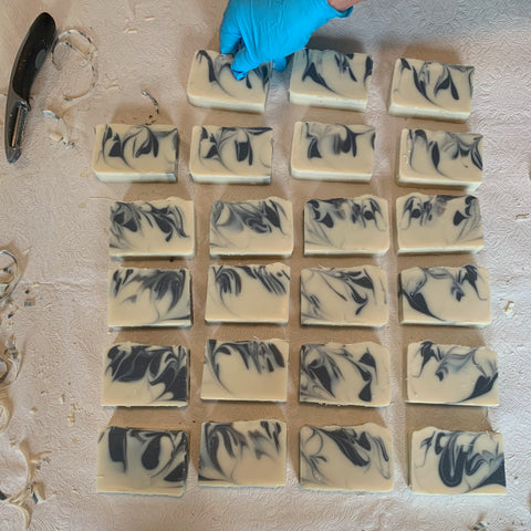 overhead shot of bars of soap with black swirls on table