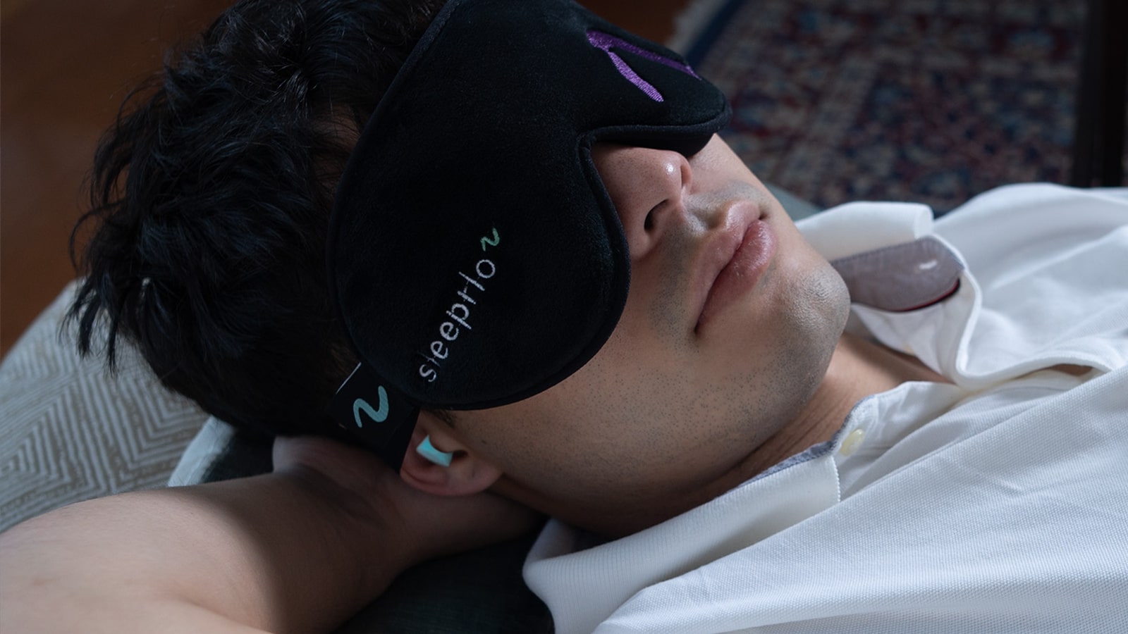 male-with-sleeprlo-mask-and-noise-reducing-ear-plugs