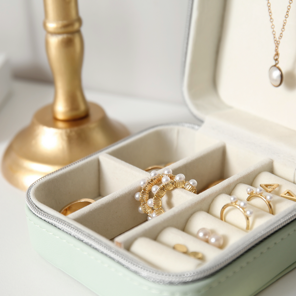 A jewelry box with separate containers to protect laser engravings on jewelry.