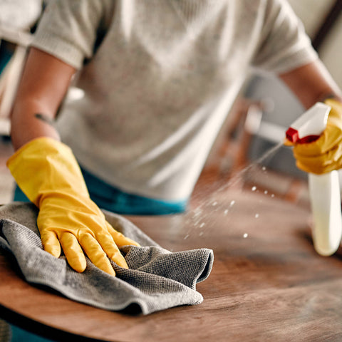 A woman wearing rubber gloves to clean her house. You can't protect your jewelry by wearing rubber gloves during cleaning.