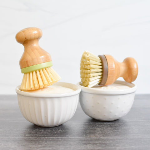 solid dish soap in ceramic ramekins with bamboo scrub brush