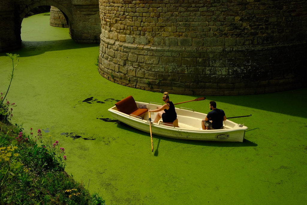 rowing in green sludge in the moat of a Brittany castle.