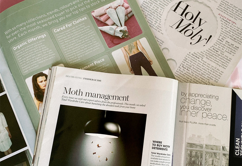 Open magazine with moth management article open on page and an image of hanging light with collection of moths