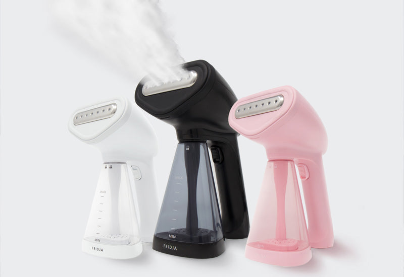 Range of Fridja hand held steamers in different colours white, pink and black