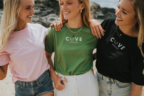 Three girls on beach with colourful t-shirts