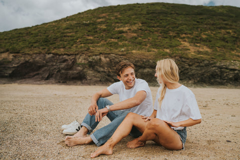 Boy and girl on beach in white t-shirts