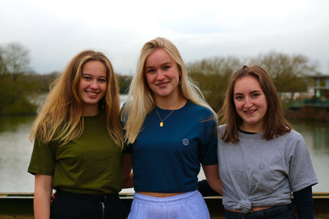 Three girls by water wearing Cove Clothing