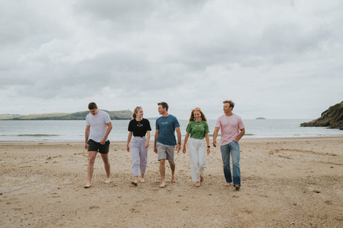 Group of 5 people wearing Cove on a beach