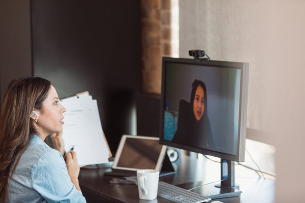 A woman using a webcam in a videoconference