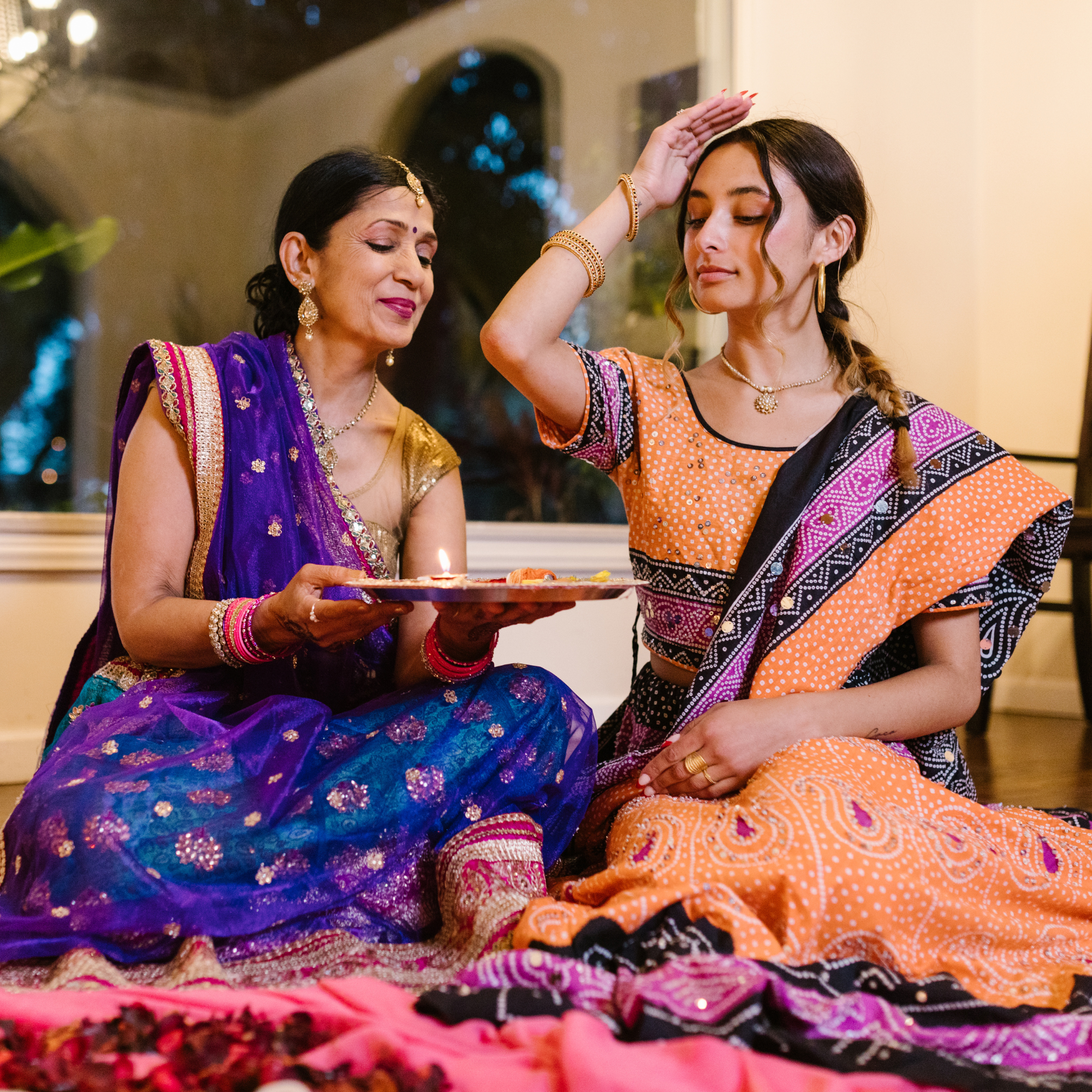 Diwali fashion - women wearing traditional South Asian clothing, holding diyas during diwali