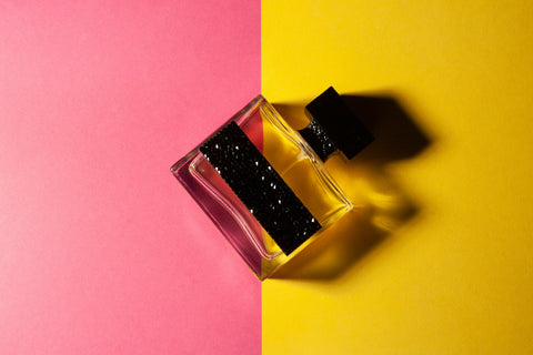 Perfume on a pink and yellow background