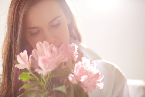 Lady smelling pink flowers