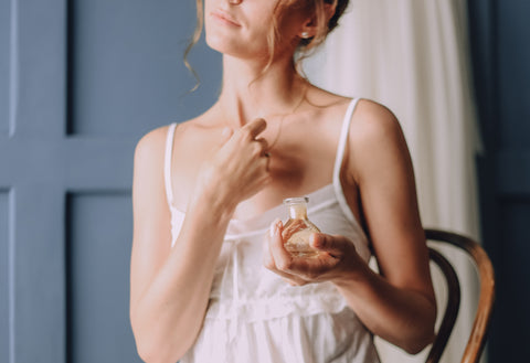 A woman using perfume in the morning